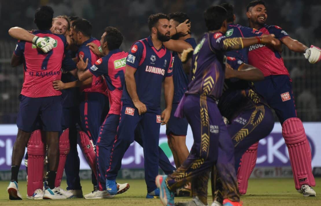 a cricket team celebrating their win as a group